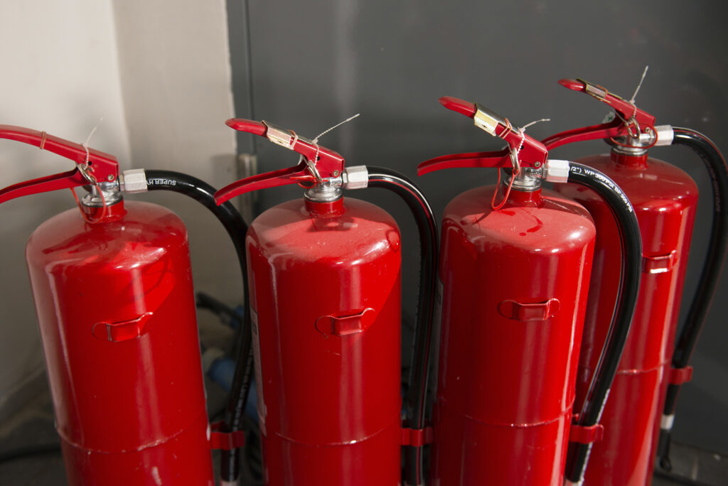 four red fire extinguishers, fire extinguisher servicing